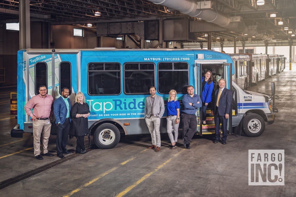 Fargo Tapride Bus With Executive Leaders In Front