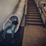 Discovery Benefits Slide with Employee going down at Fargo Office