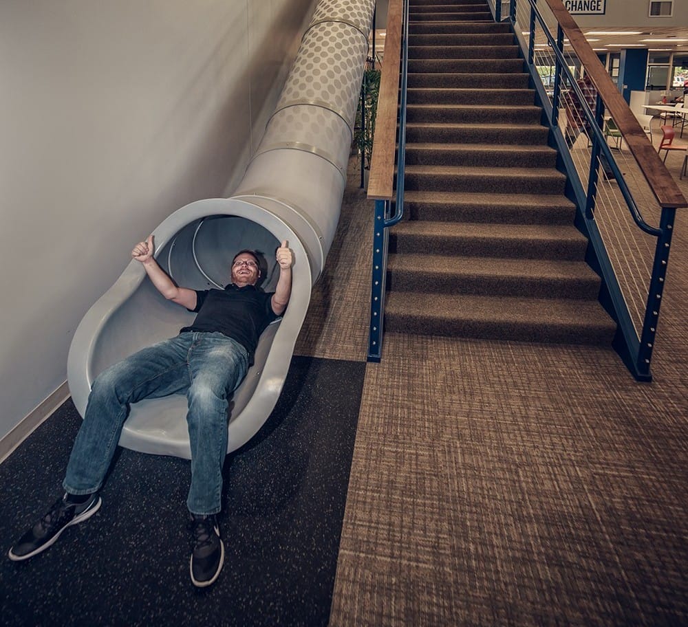 Discovery Benefits Slide with Employee going down at Fargo Office