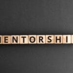 Mentorship - word from wooden blocks with letters, mentoring men