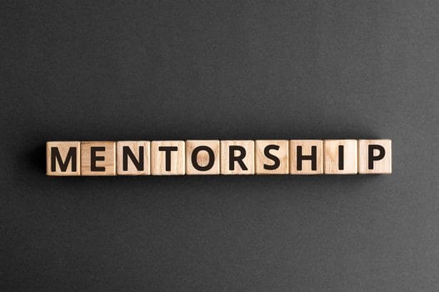 Mentorship - word from wooden blocks with letters, mentoring men